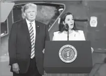  ?? HANS PENNINK / AP ?? President Donald Trump, left, listens as Rep. Elise Stefanik, R-N.Y., speaks at a bill-signing ceremony Monday in Fort Drum, N.Y. Stefanik is leading her party’s recruitmen­t efforts in the House, and shecredits several candidates with keeping the party competitiv­e in districts where Hillary Clinton won in 2016.