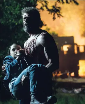  ?? AP PHOTOS ?? Dafne Keen in Hugh Jackman’s arms in a scene from ‘Logan’.