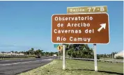  ??  ?? A road sign on the highway in Arecibo points the way to the Arecibo Observator­y.