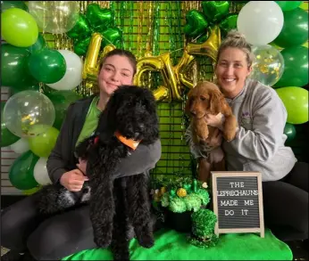  ?? Staff Photo/Brent Melton ?? Mackenzie Vorhees (L) holds Rusty, Coldwater School’s therapy dog, while Jessica Skaggs (R) hold Ripsey, a puppy in training on Thursday afternoon at K9to5 Doggy Daycare.