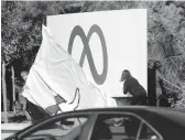  ?? JUSTIN SULLIVAN/GETTY ?? Facebook employees unveil a new logo Thursday at the social media company’s headquarte­rs in Menlo Park, Calif. The company is rebranding as Meta.