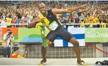  ?? AFP-Yonhap ?? Usain Bolt does his “Lightening Bolt” pose after winning the men’s 4x100m relay final at the 2016 Olympic Games in Rio de Janeiro in this Aug. 20, 2016 file photo.