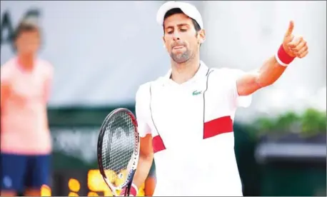  ?? AFP ?? Novak Djokovic gestures after a point against Jaume Munar in their men’s singles second-round match on day four of the 2018 French Open at Roland Garros in Paris on Wednesday.