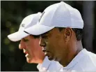  ?? CURTIS COMPTON / CCOMPTON@AJC.COM ?? Four-time Masters winner Tiger Woods and three-time winner Phil Mickelson walk down the
11th fairway while playing a practice round Tuesday.