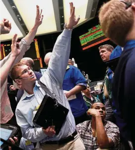  ??  ?? Cloudy sentiment: Traders working in the crude oil and natural gas options pit at the New York Mercantile Exchange. Demand for oil from US and China is uncertain due to the trade war. — Reuters