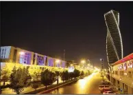  ?? (Bloomberg (WPNS)/Maya Anwar) ?? Light illuminate the Al Majdoul skyscraper and a city road at night in Riyadh, Saudi Arabia, in late July.