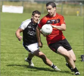  ??  ?? Brian Curran of Tubbercurr­y in action with St Mary’s Rory Guinan in Connolly Park on Sunday. Pic: Donal Hackett.
