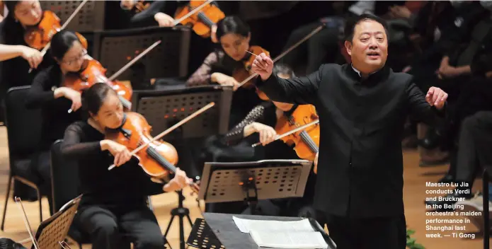  ??  ?? Maestro Lu Jia conducts Verdi and Bruckner in the Beijing orchestra’s maiden performanc­e in Shanghai last week. — Ti Gong