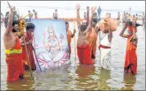  ??  ?? Devotees perform rituals at the river Ganga during Magh Mela on the occasion of Makar Sankranti, in Prayagraj, UP, on Thursday.