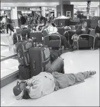  ?? AP/JOHN AMIS ?? A man sleeps Monday on the floor of Hartsfield-Jackson Atlanta Internatio­nal Airport.