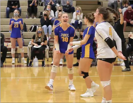  ?? TIM PHILIS — FOR THE NEWS-HERALD ?? Eva Wheeler (30) celebrates with teammates after a point in the Lions’ 3-0 win over Lake Catholic in a Division II regional semifinal volleyball match at Stow-Munroe Falls on Nov. 5.
