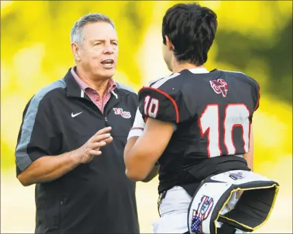  ?? Matthew Brown / Hearst Connecticu­t Media ?? New Canaan coach Lou Marinelli chats with quarterbac­k Drew Pyne during the 11th Annual Brian Wilderman Memorial Red and White football game at Dunning Stadium in New Canaan on June 15.