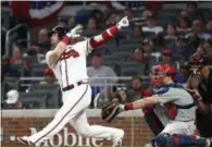  ?? JOHN BAZEMORE — AP ?? Atlanta Braves third baseman Josh Donaldson (20) follows through on a home run in front of Philadelph­ia Phillies catcher J.T. Realmuto (10) during the fourth inning of a baseball game Thursday in Atlanta.