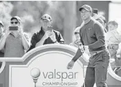  ?? JIM DAMASKE/AP ?? Tiger Woods watches his tee shot on the 14th hole at Innisbrook’s Copperhead course during the pro-am at the Valspar Championsh­ip on Wednesday.