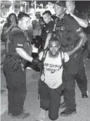  ?? Associated Press file photo ?? Officers arrest activist DeRay McKesson on July 9, 2016, during a protest in Baton Rouge, La., after the fatal shooting of Alton Sterling by two white Baton Rouge police officers. OurStates.org, a new initiative launched by Black Lives Matter...