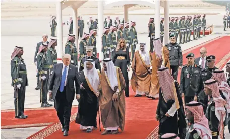  ?? EVAN VUCCI, AP ?? President Donald Trump and first lady Melania Trump arrive at the Royal Terminal of King Khalid Internatio­nal Airport on Saturday in Riyadh, Saudi Arabia.