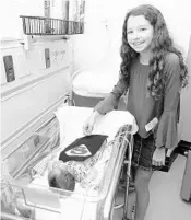  ?? ORLANDO HEALTH ?? Rachel Maretsky hands out Halloween capes she made for NICU babies.