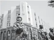  ?? Jerome Delay / Associated Press ?? Tight security surrounds Malian President Ibrahim Boubacar Keita as he visits the Radisson Blu hotel on Saturday. A terrorist group linked to al-Qaida Africa claimed responsibi­lity for the attack.