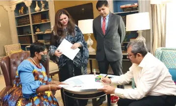  ?? ?? Angel of Hope Foundation founder and patron First Lady Dr Auxillia Mnangagwa exchanges Memorandum of Understand­ing documents with Indian Economic Trade Organisati­on President Mr Asif Iqbal and Mrs Hema Agnihotri while Zimbabwe India Trade Council Commission­er Mr Shailendra Jain look on in New Delhi, India, on Friday