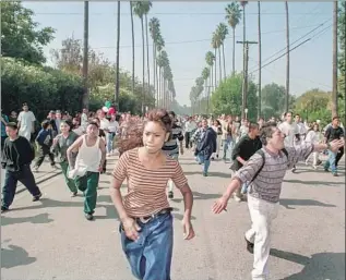  ?? Brian van der Brug Los Angeles Times ?? FOR MANY young Latinos, Prop. 187 awakened an activist spirit that hasn’t waned. Above, students from Monroe High run toward police blocking access to Van Nuys High on Oct. 28, 1994.