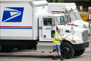  ?? Steph Chambers/Post-Gazette ?? A worker exits a vehicle Tuesday at the United States Postal Service facility in Pittsburgh’s California-Kirkbride neighborho­od.