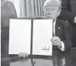  ?? POOL PHOTO ?? President Trump displays an executive order that he signed Feb. 3 in the Oval Office of the White House.