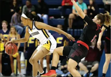  ??  ?? Louisville guard Mykasa Robinson (5) falls as she collides with Chattanoog­a guard Mya Long (3) in the second half of an NCAA college basketball game Friday, in Chattanoog­a, Tenn. Louisville won 75-49. (AP Photo/Mark Humphrey). AP PHOTO/RUSSELL CONTRERAS