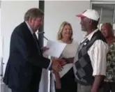  ??  ?? Businessma­n Johan Rupert handing a title deed certificat­e to one of the recipients.