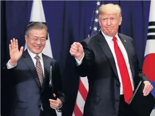  ?? Reuters ?? South Korean President Moon Jae-in and US President Donald Trump gesture after signing the US-Korea Free Trade Agreement during a ceremony in New York. —