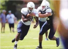  ?? STAFF PHOTO BY ERIN O. SMITH ?? UTC running back Jonathan Stovall runs with the ball during practice Monday. He hasn’t played since 2015.