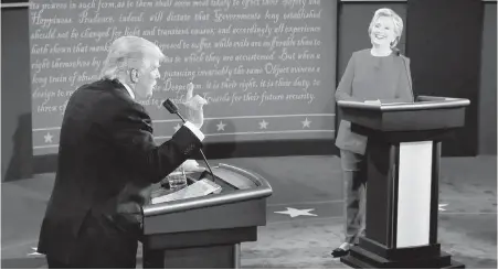  ??  ?? Democratic presidenti­al nominee Hillary Clinton reacts as Republican nominee Donald Trump speaks during Monday’s debate.