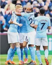  ??  ?? Manchester City players celebrate after scoring in London on Sunday