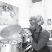  ?? JON SUPER/AP ?? Glenda Andrew prepares West Indian meals with members of the Preston Windrush Covid Response team last month at the Xaverian Sanctuary in Preston, England.