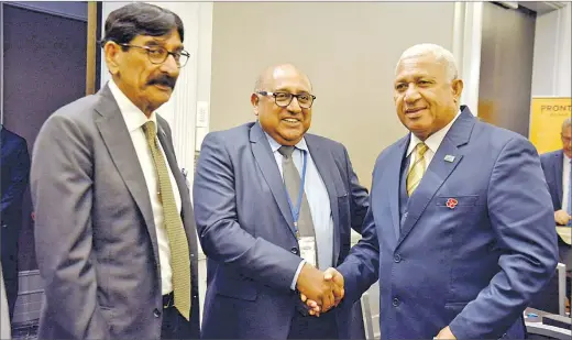  ?? Picture: AQELA SUSU ?? Prime Minister Voreqe Bainimaram­a meets Pricewater­houseCoope­rs Territory senior partner Nitin Gandhi (middle) and Fiji’s honorary consul in Brisbane Hari Raniga after the opening of the 25th Australia-Fiji Business Forum in Brisbane on Thursday.