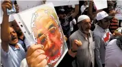  ?? KHALID MOHAMMED THE ASSOCIATED PRESS ?? Protesters chant slogans and carry banners against the Iraqi Supreme Court’s top judge, Midhat al-Mahmoud, during a demonstrat­ion Monday in Baghdad.