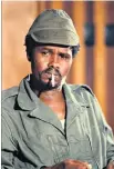  ??  ?? Habré raising his fist during his trial in Senegal in 2016 and, right, in 1979, modelling his look on Cuban revolution­aries