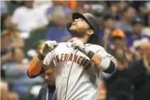  ?? Morry Gash / Associated Press ?? Shortstop Brandon Crawford reacts after hitting a home run in the ninth inning to put the Giants ahead 65.