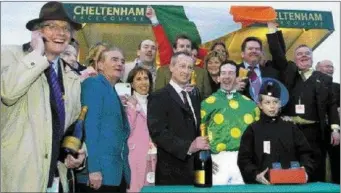  ??  ?? Team ‘Total Enjoyment’ on the winner’s podium after the mare’s historic win at Cheltenham in 2004.
