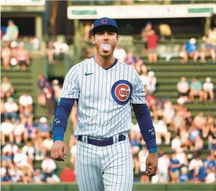  ?? TERRENCE ANTONIO JAMES/CHICAGO TRIBUNE ?? Cubs first baseman Cody Bellinger blows a bubble before a game against the Reds on July 31 at Wrigley Field.