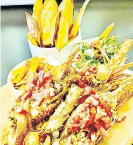  ??  ?? Pizzazz grilled lobster served with lobster ceviche, sweet potato fries and a side salad.