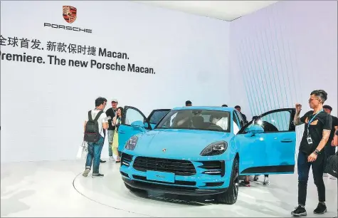  ?? PHOTOS PROVIDED TO CHINA DAILY ?? Porsche’s revamped Macan mid-sized SUV catches attention at its global premiere in Shanghai last Wednesday.