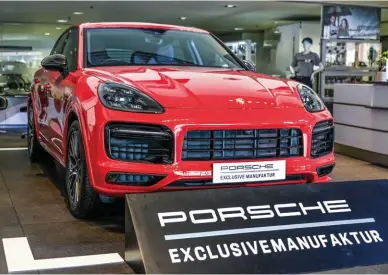  ?? ?? Left: This Cayenne GTS is the only one of its kind. Below: Porsche Design Subsecond clock; Exclusive Design gear selector with a customised key fob and cover; Porsche Rear Seat Entertainm­ent pack on the Cayenne GTS; Porsche crest in the headrest