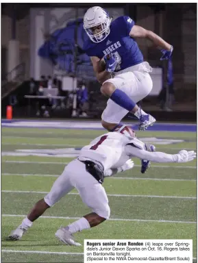  ?? (Special to the NWA Democrat-Gazette/Brent Soule) ?? Rogers senior Aron Rendon (4) leaps over Springdale’s Junior Davon Sparks on Oct. 16. Rogers takes on Bentonvill­e tonight.