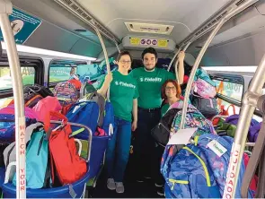  ?? COURTESY OF FIDELITY INVESTMENT­S ?? Fidelity Investment­s employees with school supplies from a special drive event.