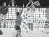  ?? MICHAEL CONROY — THE ASSOCIATED PRESS ?? Gonzaga guard Jalen Suggs (1) shoots over UCLA guard David Singleton (34) to win the game during overtime in a men’s Final Four NCAA college basketball tournament semifinal game, Saturday at Lucas Oil Stadium in Indianapol­is. Gonzaga won 93-90.