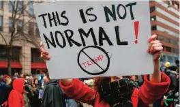  ??  ?? WASHINGTON: A protester holds a sign during a demonstrat­ion in Washington, Friday, Jan 20, 2017, after the inaugurati­on of President Donald Trump.