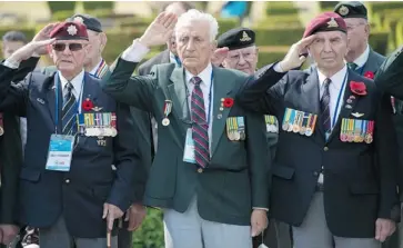  ?? ADRIAN WYLD/THE CANADIAN PRESS ?? Canadian Korean War veterans Ellroy Faulkner, left, Joseph Ritchie and Aime Michaud salute as they take part in a Canadian ceremony at the United Nations Memorial Cemetery in South Korea on Friday.