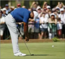  ?? CHARLIE RIEDEL — THE ASSOCIATED PRESS ?? Tiger Woods reacts to a missed birdie putt on the 11th green on Saturday. The Associated Press