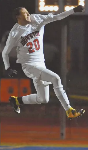  ?? STAFF PHOTOS BY CHRIS CHRISTO ?? COMEBACK KIDS: Brockton’s Odair Monteiro gets some air after assisting on the tying goal during yesterday’s 5-3 win against Longmeadow in the Division 1 boys soccer state final in Worcester. At right, Boxers players (from left) Claudio Mascarenha­s and...