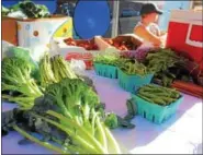  ??  ?? Produce such as broccoli, radishes and asparagus are on display during an outdoor farmers market in Pottstown. Asparagus is on the “Clean 15” list which is a group of vegetables and fruits found to be the least likely to have pesticide residues when...